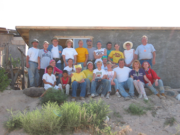 June 2004: Peggy and her family traveled to La Gloria Mexico (south of Tijuana) with their church to help build homes. Peggy is pictured with the crew she worked with to build one of the eight homes completed by the end of the week of service.